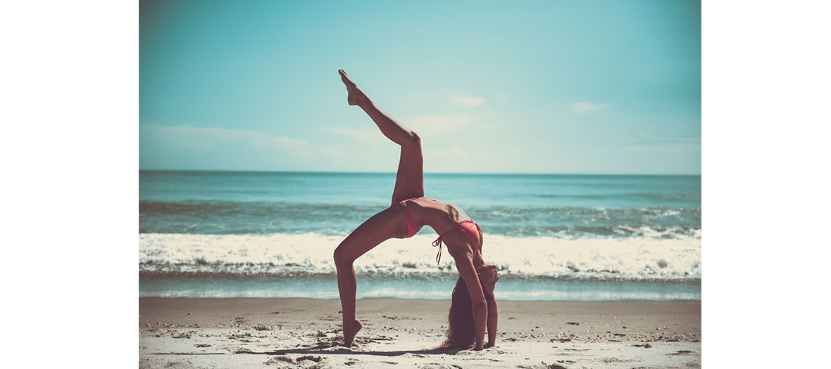 women at the beach exercising