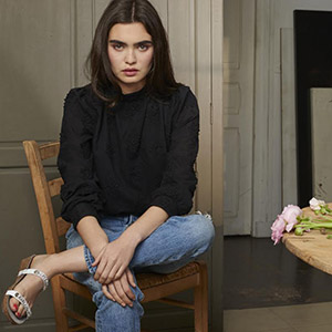 Model sitting on a chair and wearing Flolove's clothes