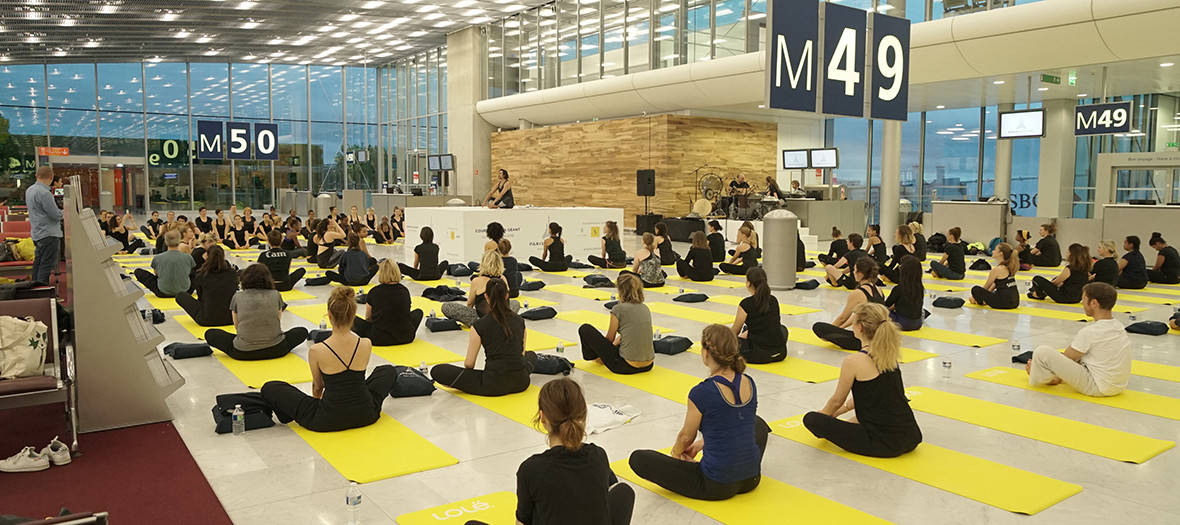 people doing yoga in a room boarding 