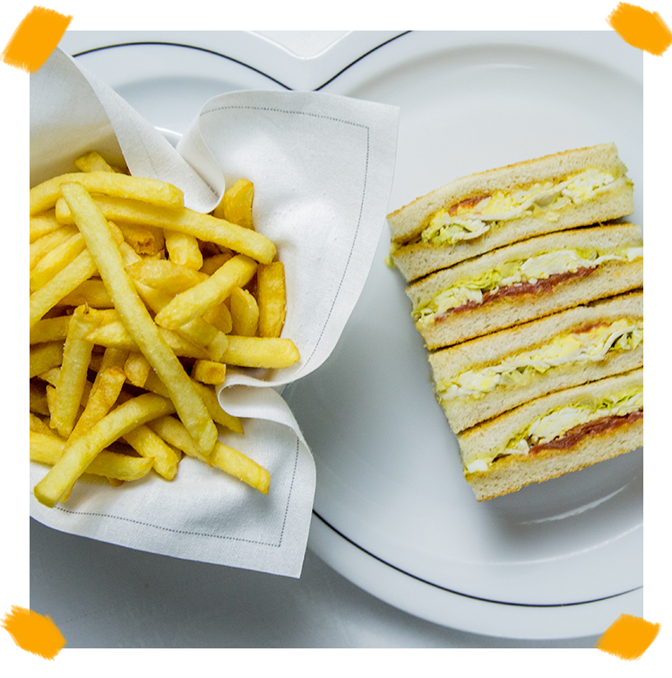 The veggie sandwich club with chicken, salmon and french fries