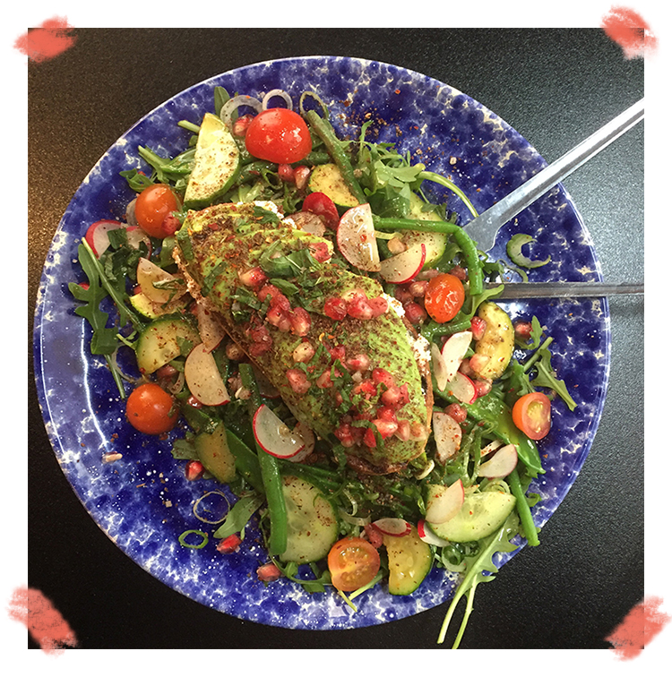 Avocado toast with a slice of toasted bread with fresh cheese and Kalios olive oil, covered with sliced avocado, radish, spring onions and fresh pomegranate—sprinkled with aromatic herbs of the restaurant Bagnard in Paris