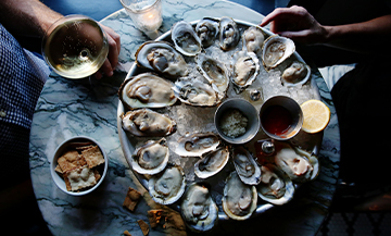 An oyster mushroom with lemon, spices and glass of Champagne