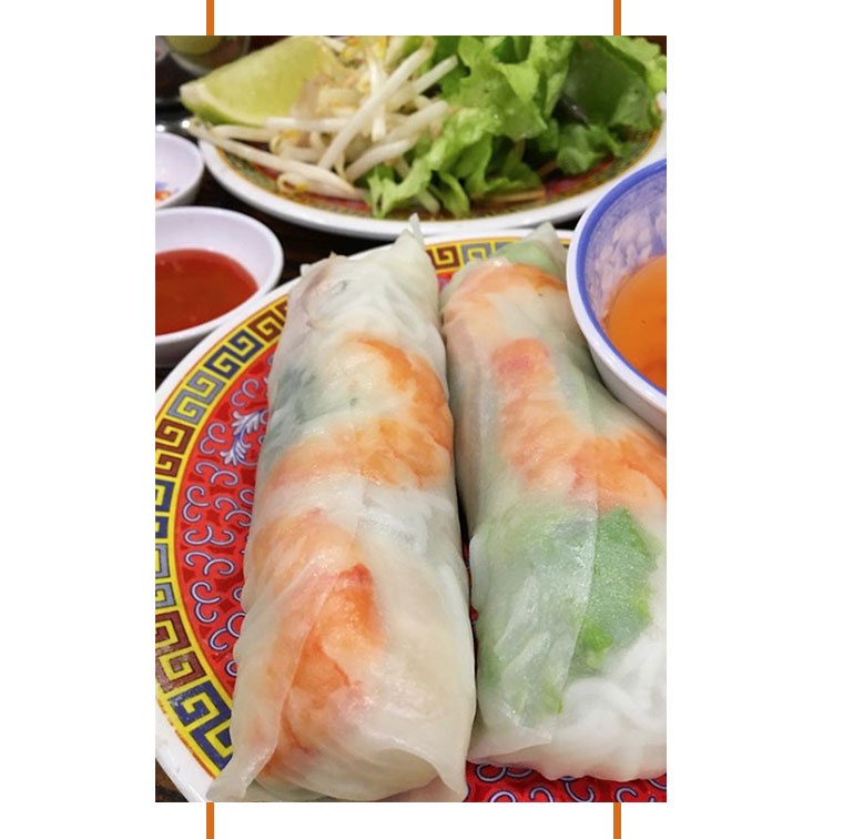 Spring rolls with shrimps, rice vermicelli, salad and thai basil.