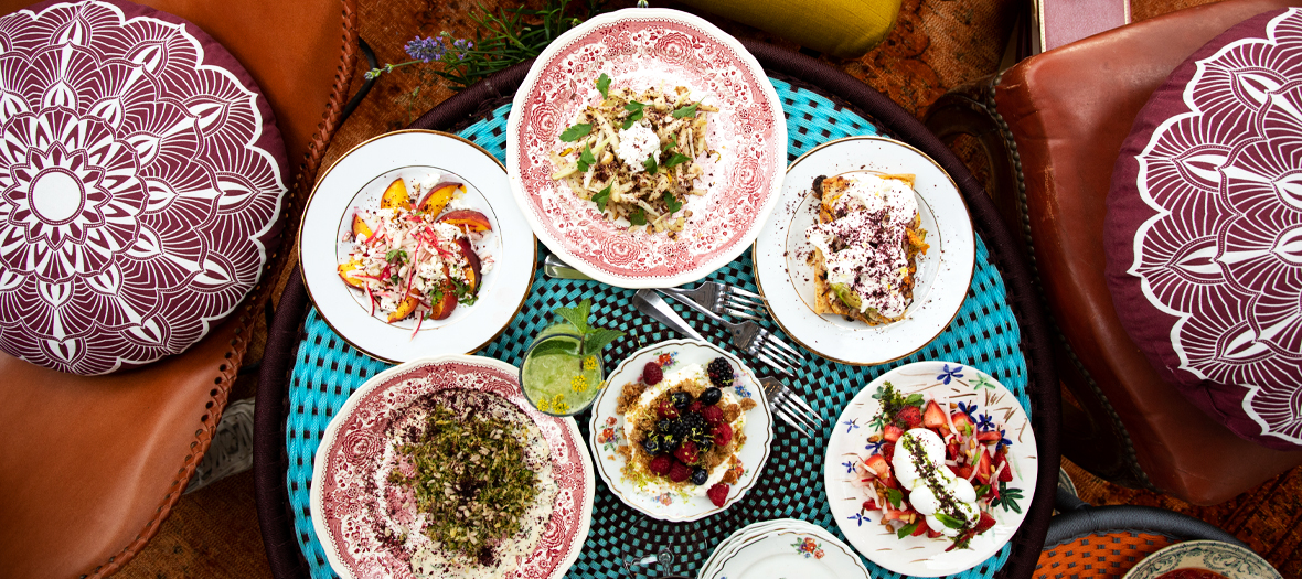 Plate to share including,  potato salad, egg, red onion and capers, salty salad with peaches, spring onions, radish and feta, mozzarella and gariguette strawberries or a focaccia with flower of courgettes and burrata