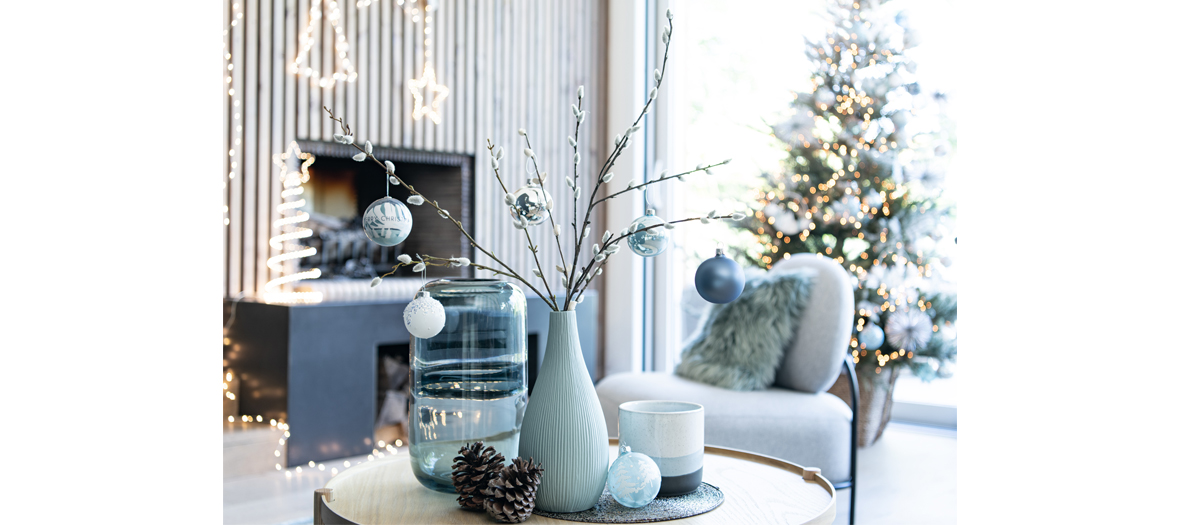 Ice Christmas collection from maison du monde that includes white palm tree leaves, branches of frosty eucalyptus and Christsmas balls with a polar ice print.