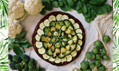 Low calorie pizza with cauliflower, broccoli, zucchini, asparagus, goat cheese, egg, spirulina, minced basil, tomato puree