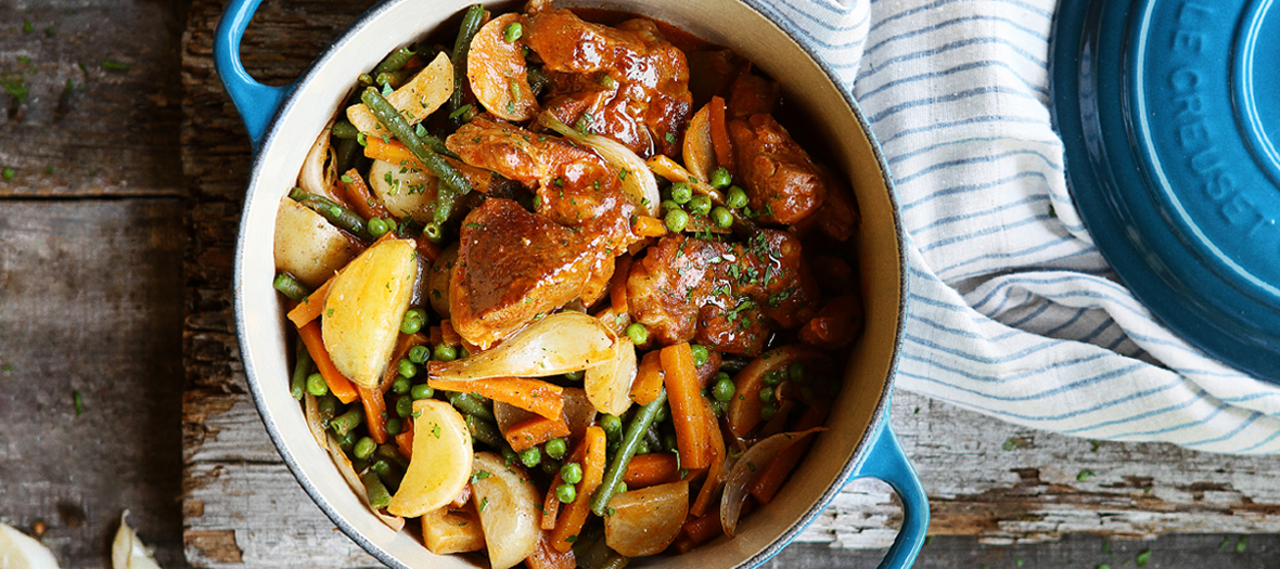 Plat de navarin d’agneau avec navets, carottes, oignons, tomate, haricots verts, pommes de terre, petits pois