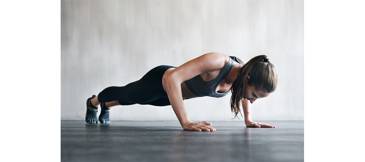 Young girl making push ups