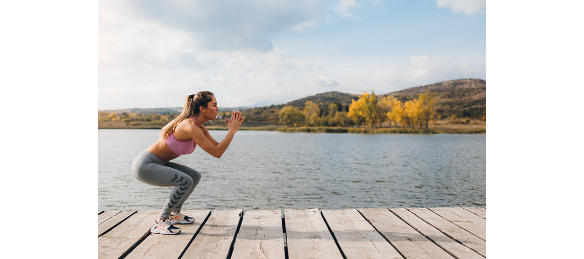 Young girl making squat jumps