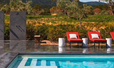 A large pool surrounded by vineyards at the Ultimate Provence hotel