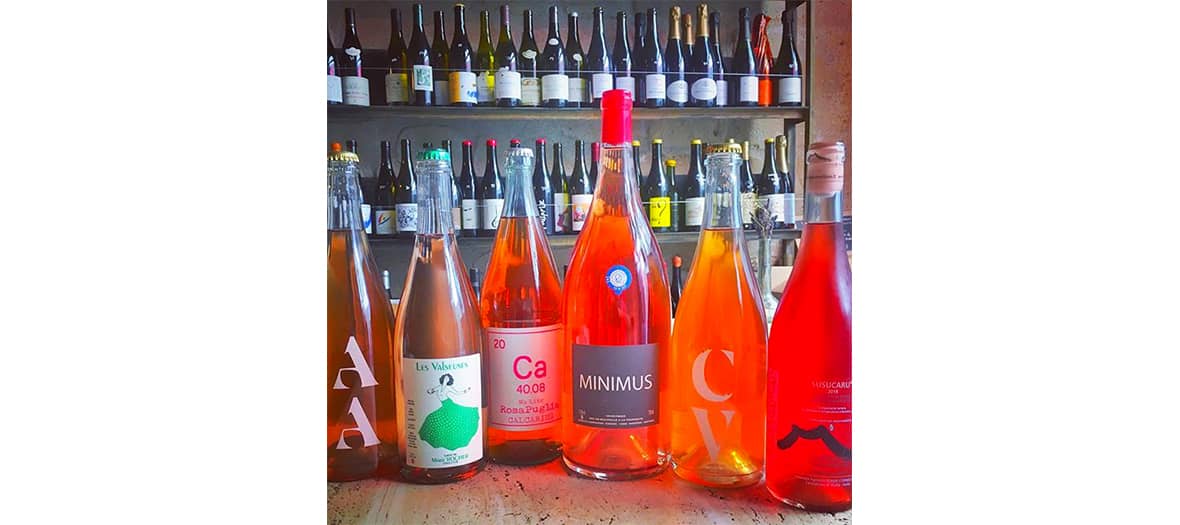 Orange wine bottles at Augustin organic wine bar in Paris