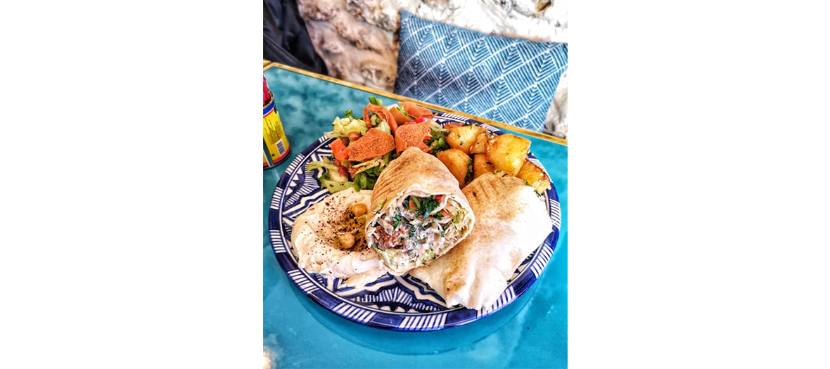 Dish of ultra generous mezze from labneh, hummus, tabbouleh, moussaka, eggplant caviar