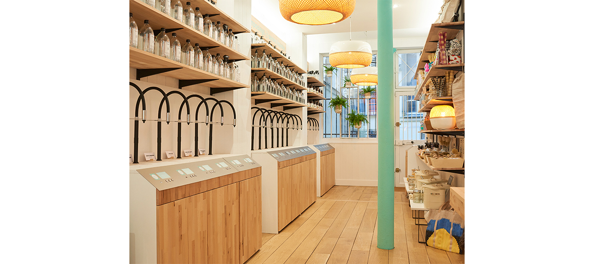  Interior decoration of the wooden concept store The Naked Shop with glass bottles