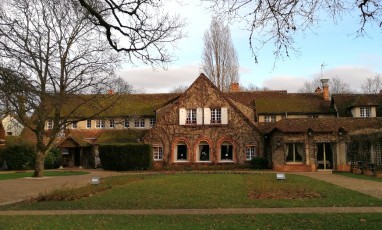 Facade with a lawn in the garden of the Auberge des Templiers