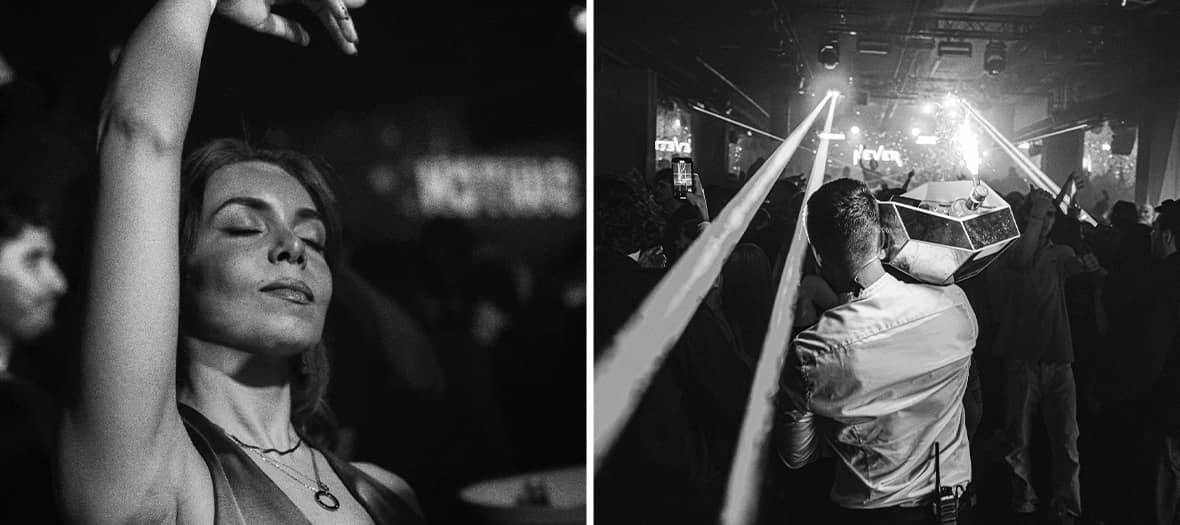 Danseurs en silhouette sous des lumi&egrave;res color&eacute;es dans un club parisien.