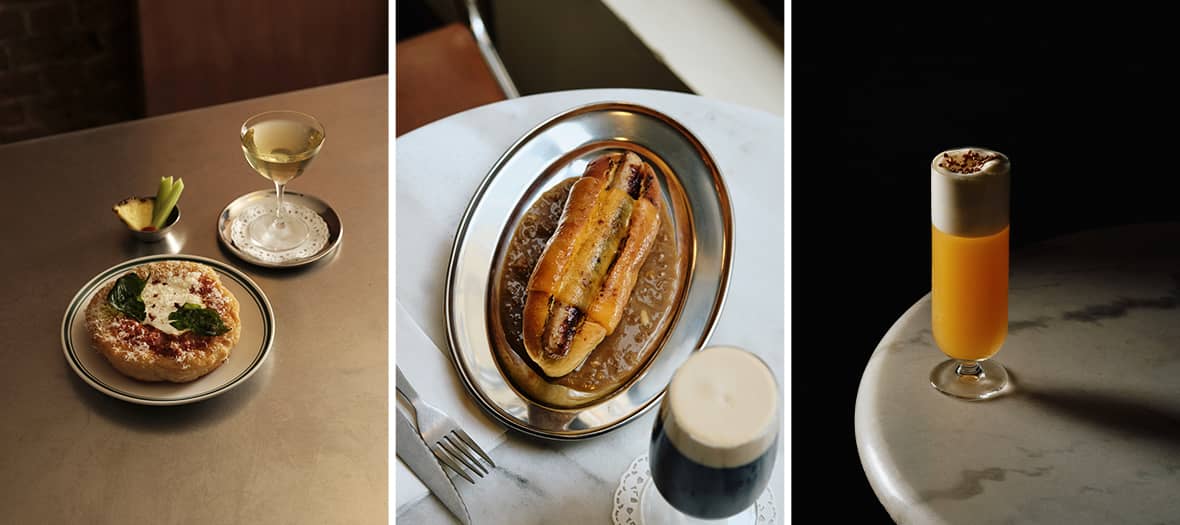 Assiette de street-food et cocktail chez Superfine Paris, hot-dog servi sur plateau inox et cocktail mousseux sur table en marbre.
