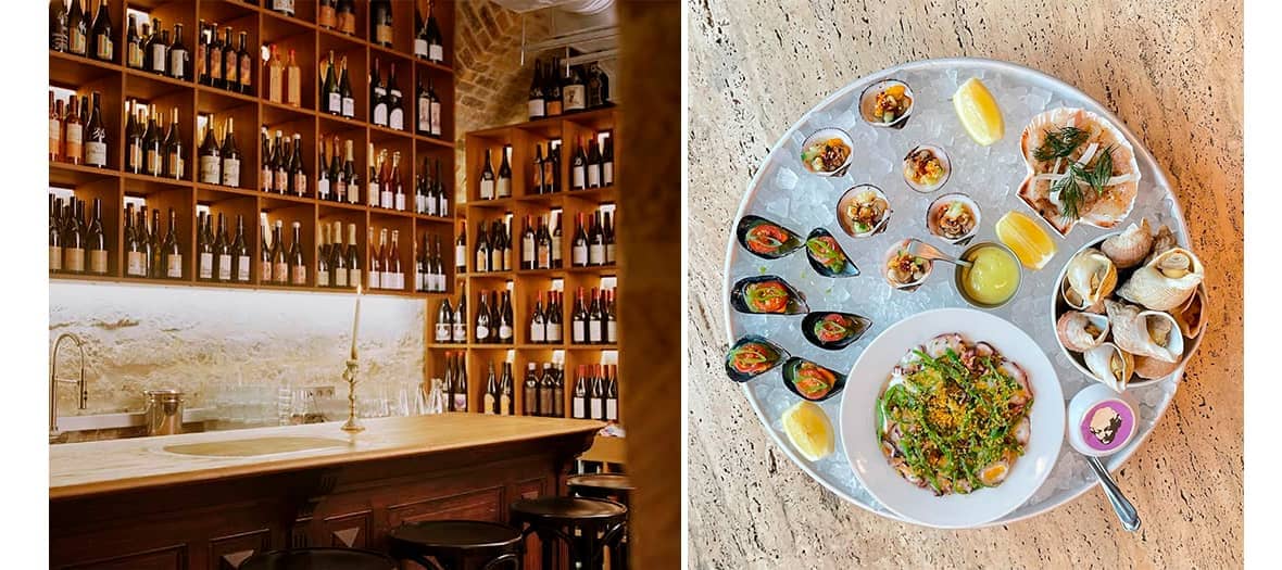 Mur de bouteilles dans un bar à vins et plateau de fruits de mer au Collier de la Reine à Paris.