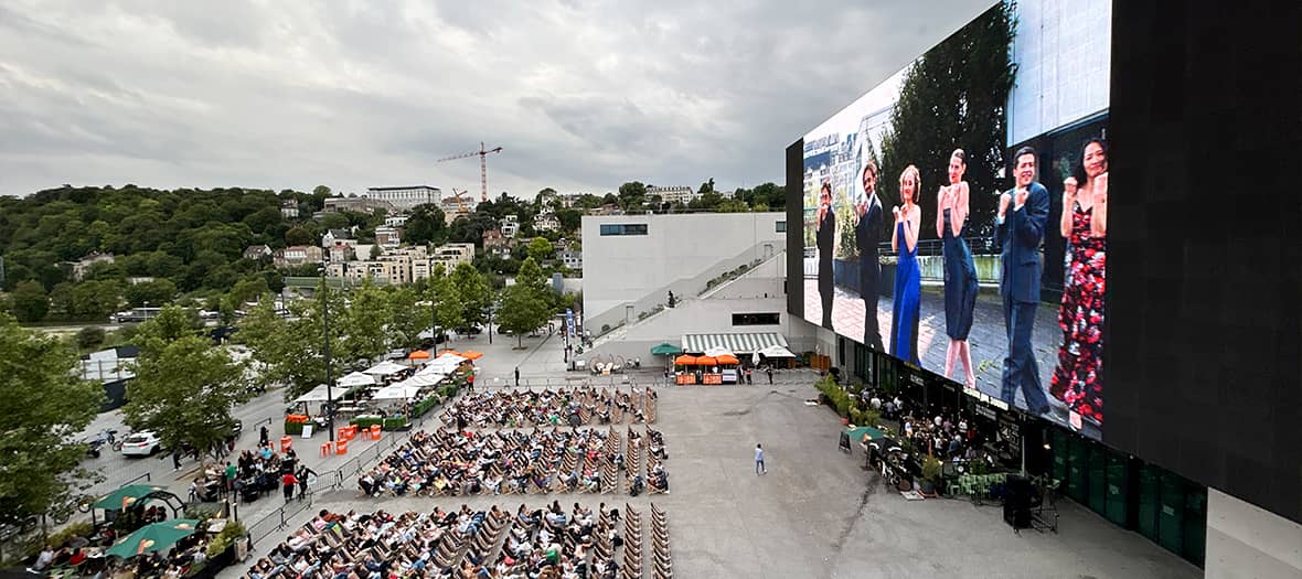 Projection en plein air à La Seine Musicale, grand écran LED en façade avec public nombreux à Boulogne-Billancourt.